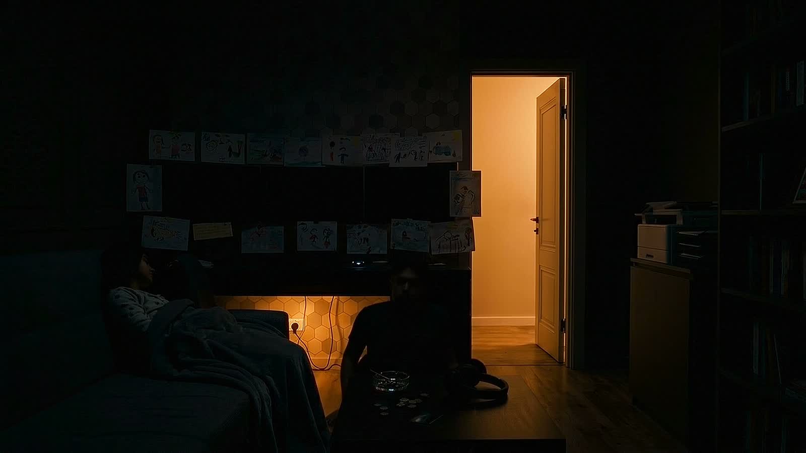 The last shot: the monitors are off, and the only light left in the room is the one from her doorway.